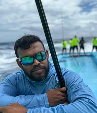 Portrait of a Maldivian fisherman with a pole onboard during traditional tuna fishing