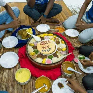 Maldivian communal meal served on the floor – featuring traditional curry, rice and fish dishes